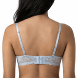 Woman wearing a light blue bra against a white background