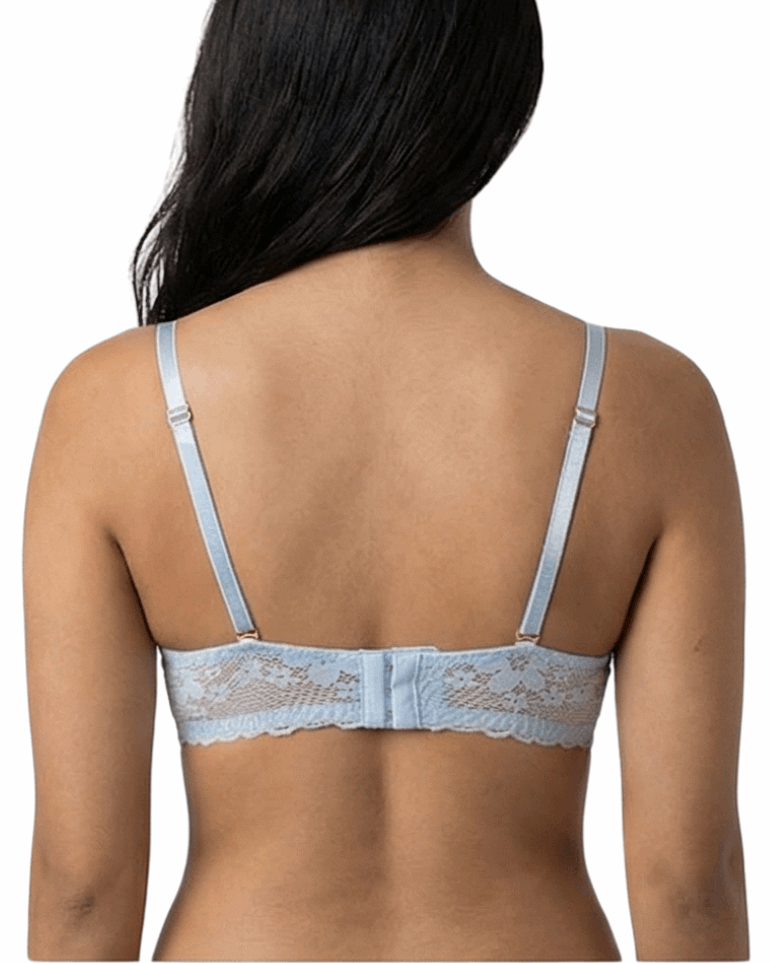 Woman wearing a light blue bra against a white background