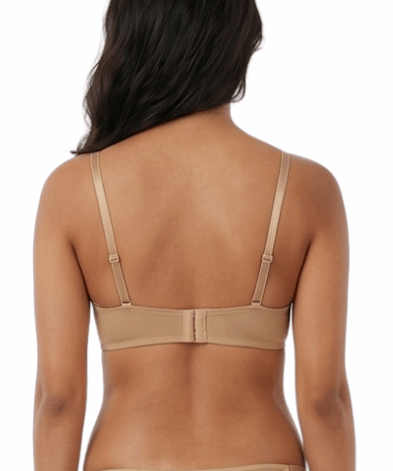 Woman wearing a beige lingerie set on a white background