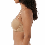 Woman wearing a beige bikini on a white background