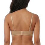 Woman wearing a beige lingerie set on a white background