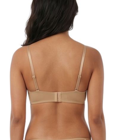 Woman wearing a beige lingerie set on a white background