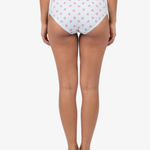 Rear view of a model wearing blue hipster bottoms with a pink strawberry pattern, set against a plain light gray background.