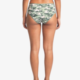 Rear view of a model wearing camouflage hipster bottoms against a light gray studio background.