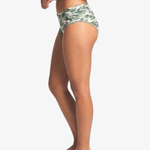 Side view of a model wearing camouflage hipster bottoms against a plain light gray background.