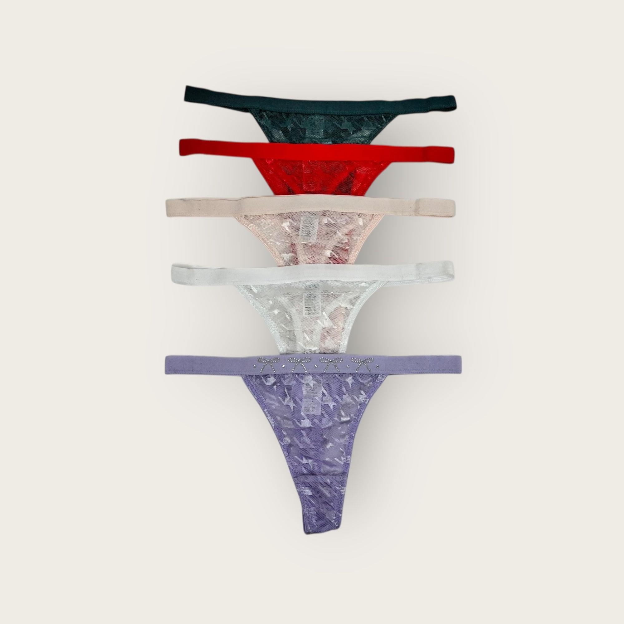 Five pairs of women's underwear in various colors on a white background