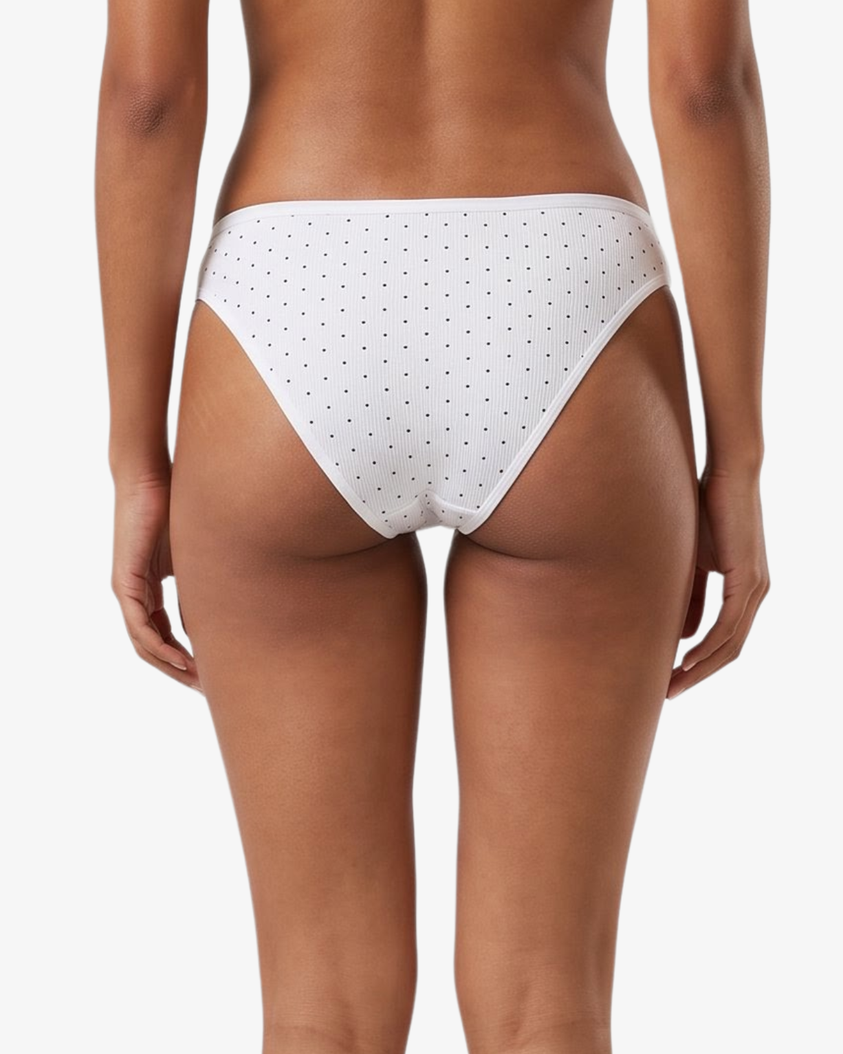 White bikini bottom with small black polka dots, shown on a model against a light gray background.