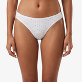 White bikini bottom with small black polka dots, shown on a model against a light gray background.