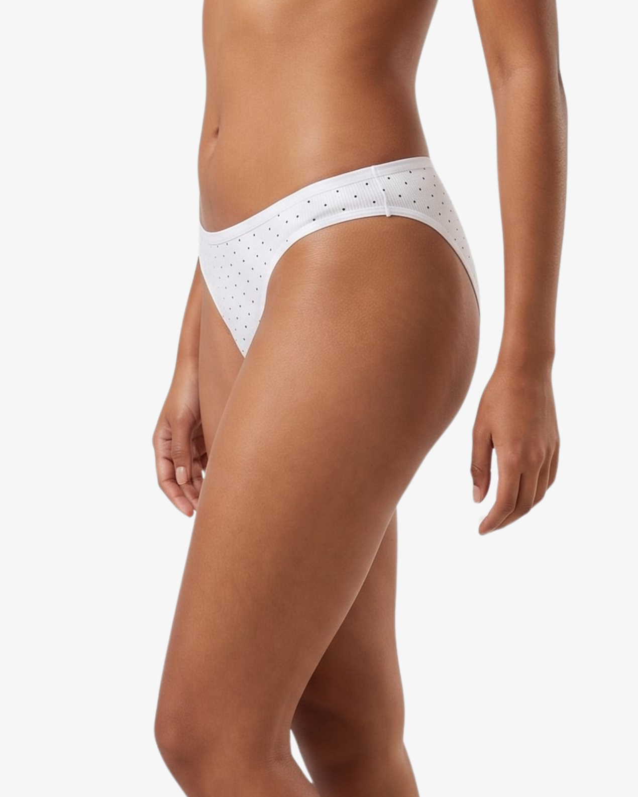 White bikini bottom with small black polka dots, shown on a model against a light gray background.