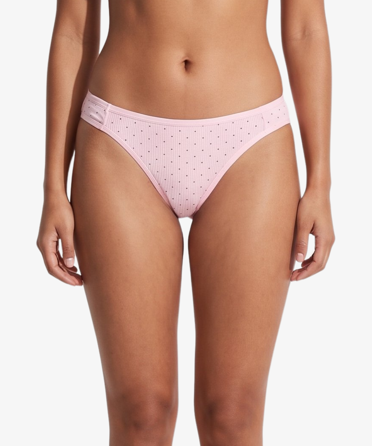 Pink bikini bottom with small brown polka dots, shown on a model against a light gray background.