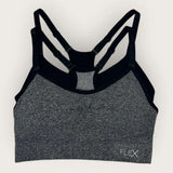 Gray sports bra with black straps on a white background