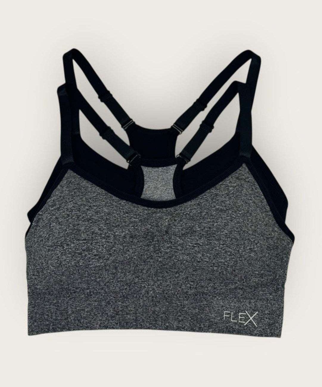 Gray sports bra with black straps on a white background