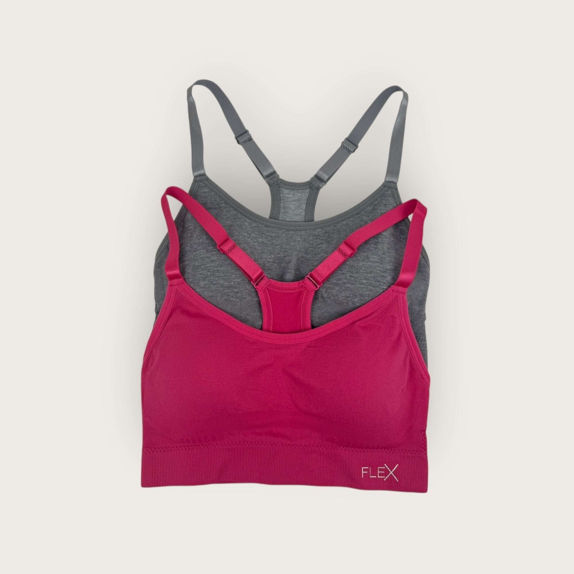Pink and gray bra set on a light beige background