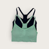 Green and black sports bra on a white background