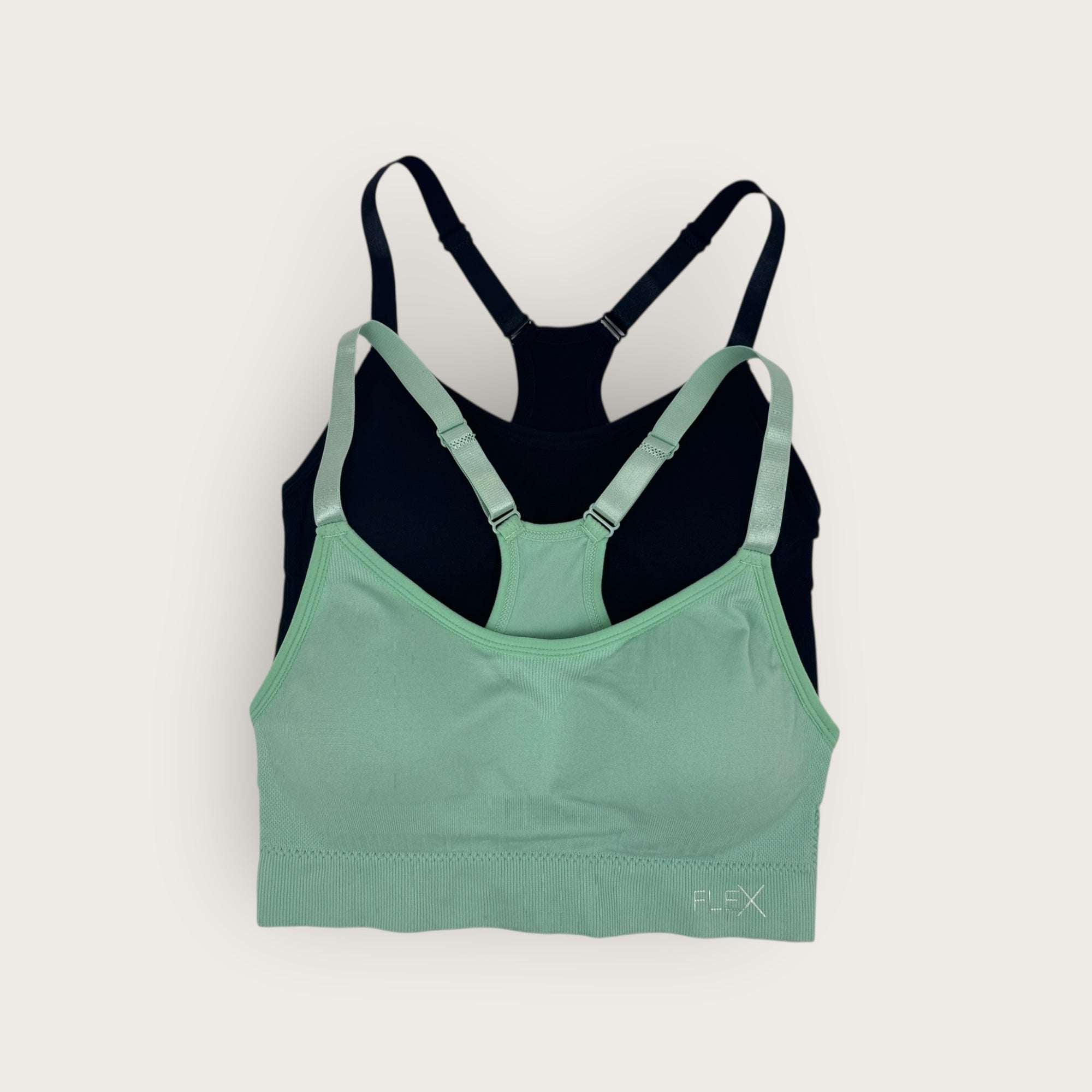 Green and black sports bra on a white background