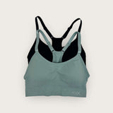 Green and black sports bra on a white background