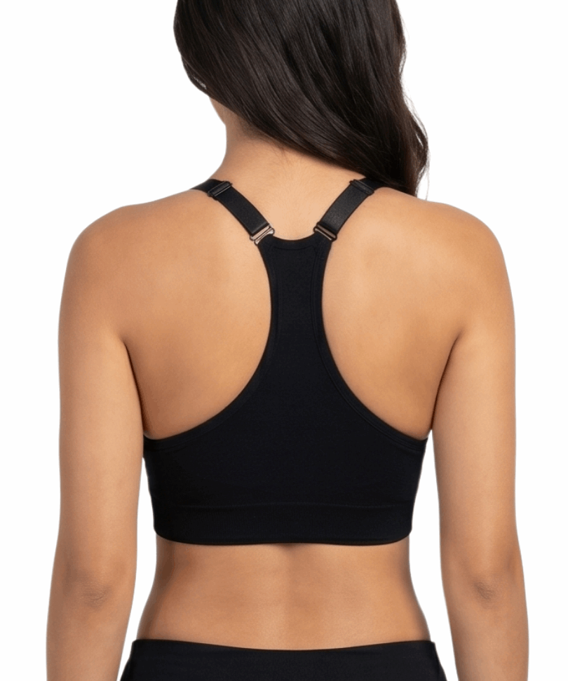 Woman in a black sports bra against a white backround.