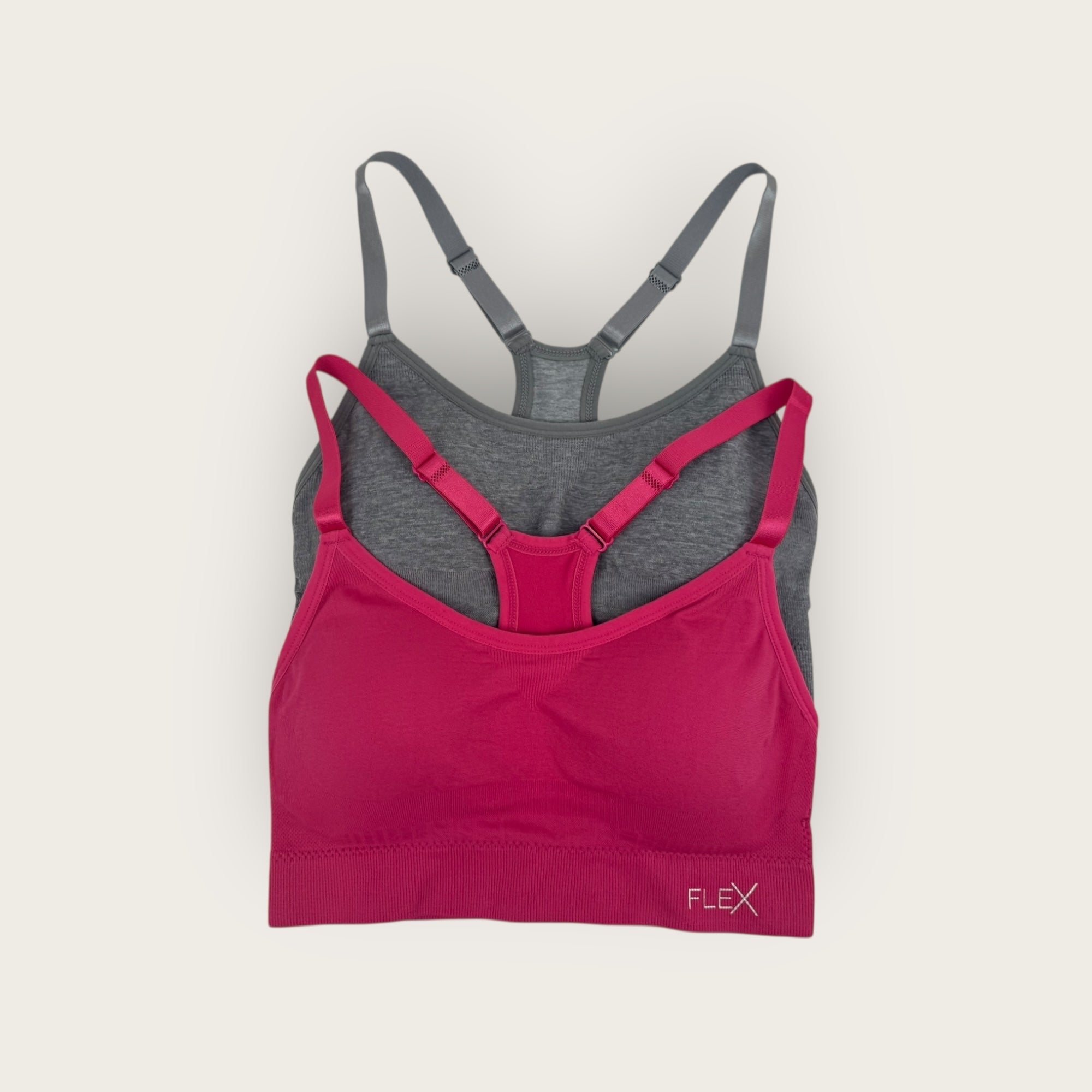 Pink and gray bra set on a light beige background