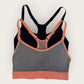 Multicolored sports bra with 'Flex' branding on a light gray background