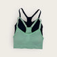 Green and black sports bra on a white background