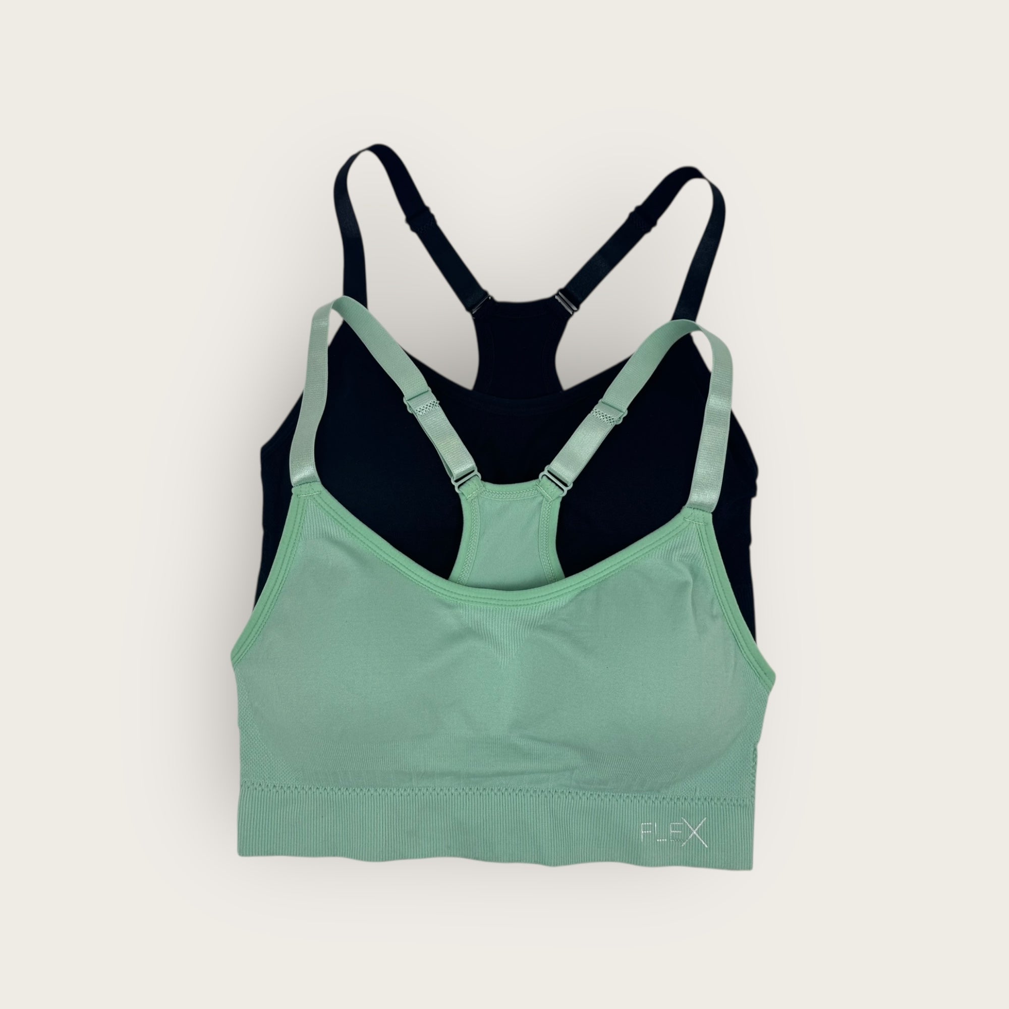 Green and black sports bra on a white background