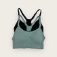 Green and black sports bra on a white background