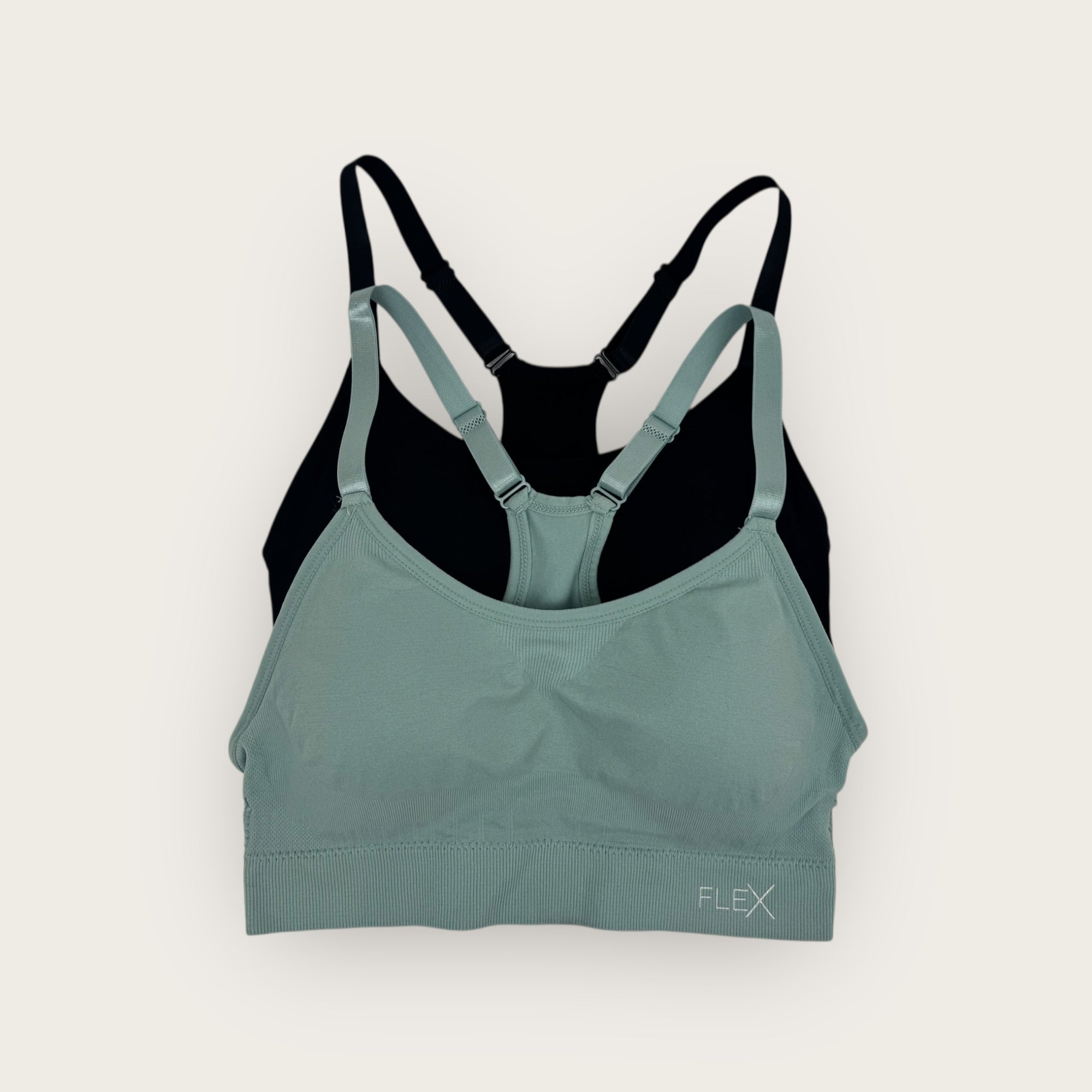 Green and black sports bra on a white background