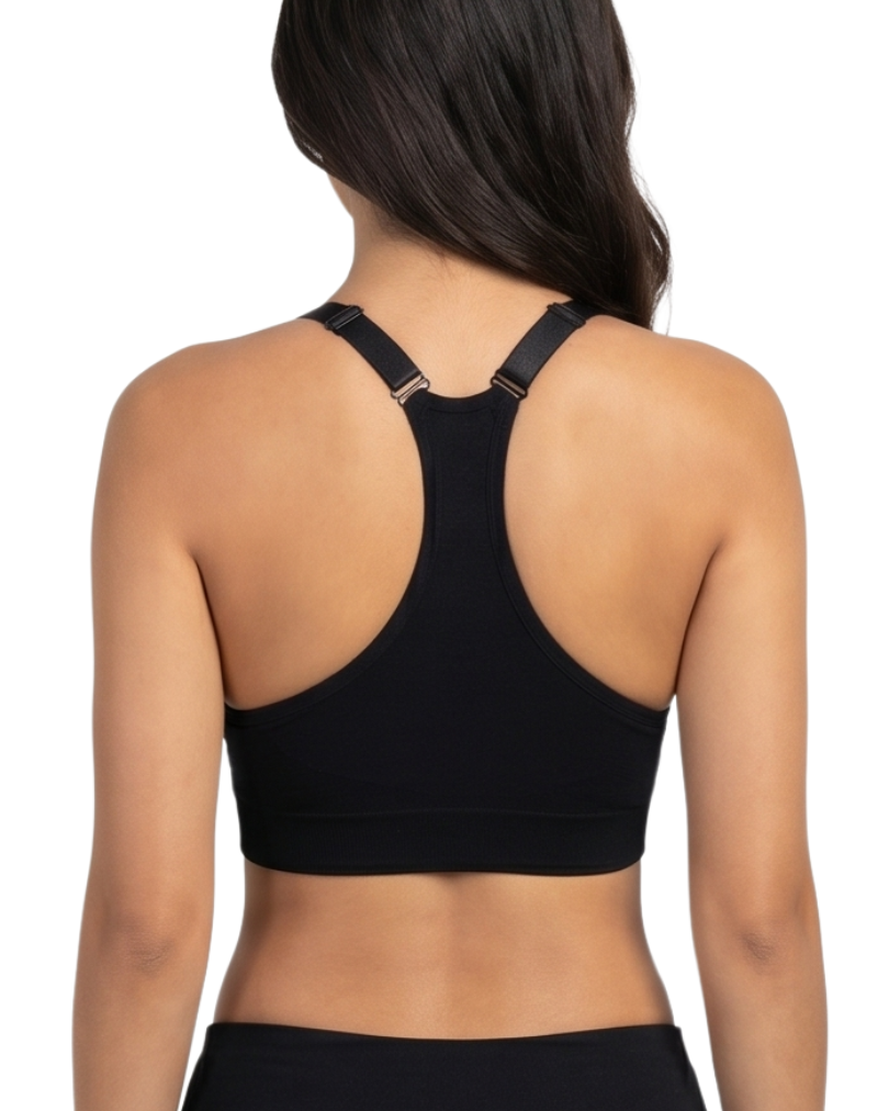 Woman in a black sports bra against a white backround.