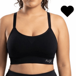 Woman in a black sports bra against a white background. 