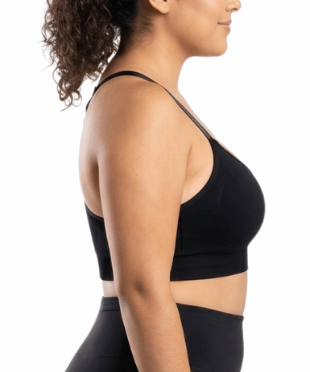 Woman in a black sports bra against a white background.