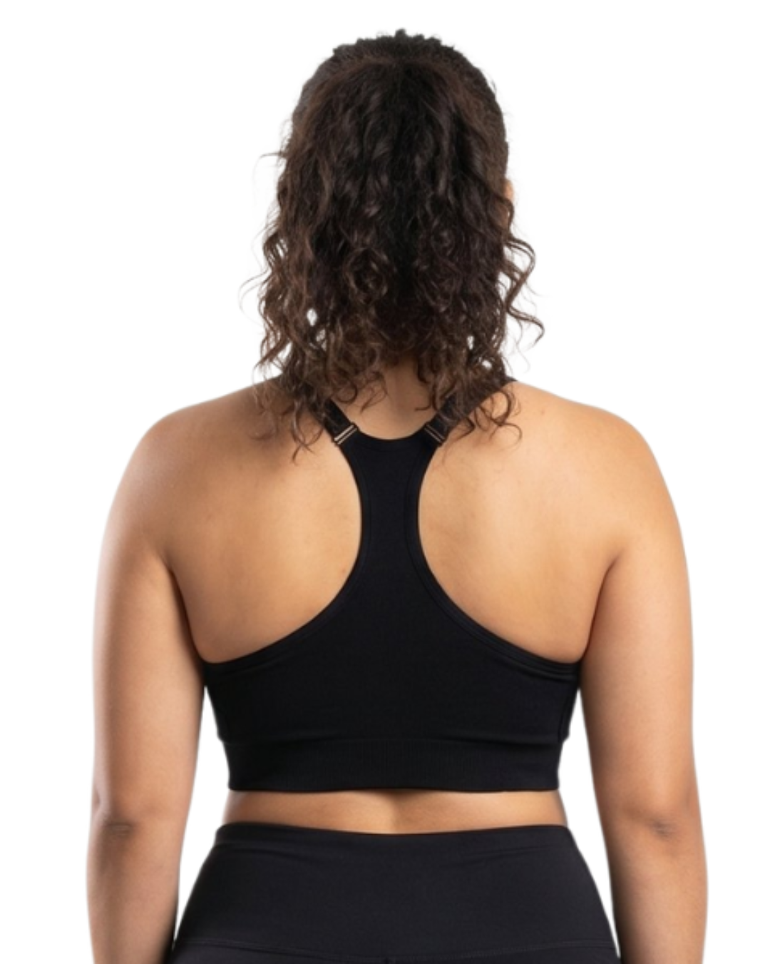 Woman in a black sports bra against a white background.