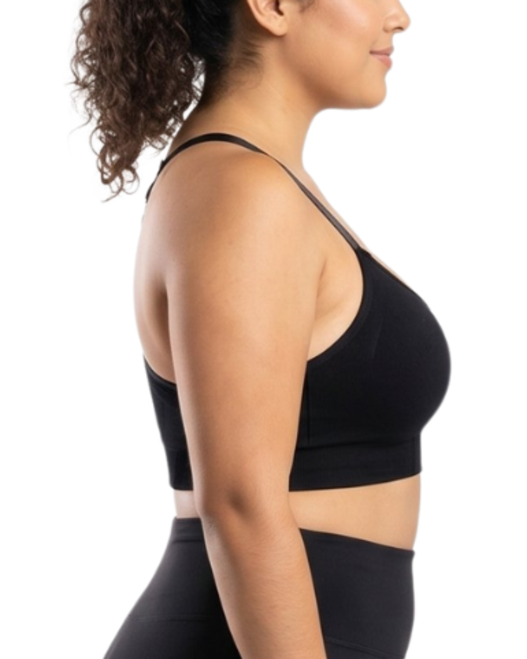 Woman in a black sports bra against a white background.