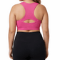 Woman wearing a pink sports bra and black leggings on a white background