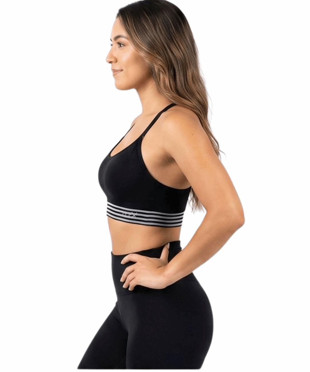 Woman wearing a black sports bra with striped design and matching leggings on a white background