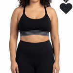 Woman wearing a black sports bra and leggings on a white background