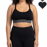 Woman wearing a black sports bra and leggings on a white background