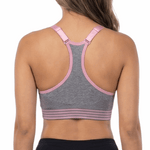 Woman wearing a sports bra and black leggings on a white background