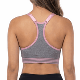 Woman wearing a sports bra and black leggings on a white background