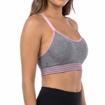 Woman wearing a gray sports bra and black leggings on a white background