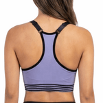 Woman wearing a purple sports bra and black leggings on a white background