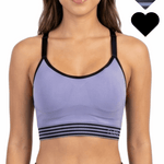 Woman wearing a purple sports bra with black straps on a white background