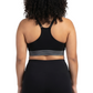 Woman wearing a black sports bra and leggings on a white background
