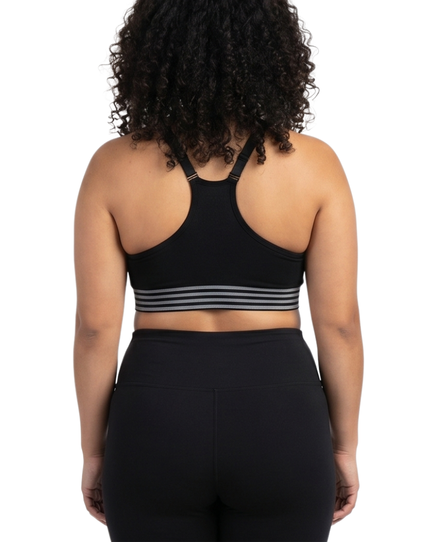 Woman wearing a black sports bra and leggings on a white background