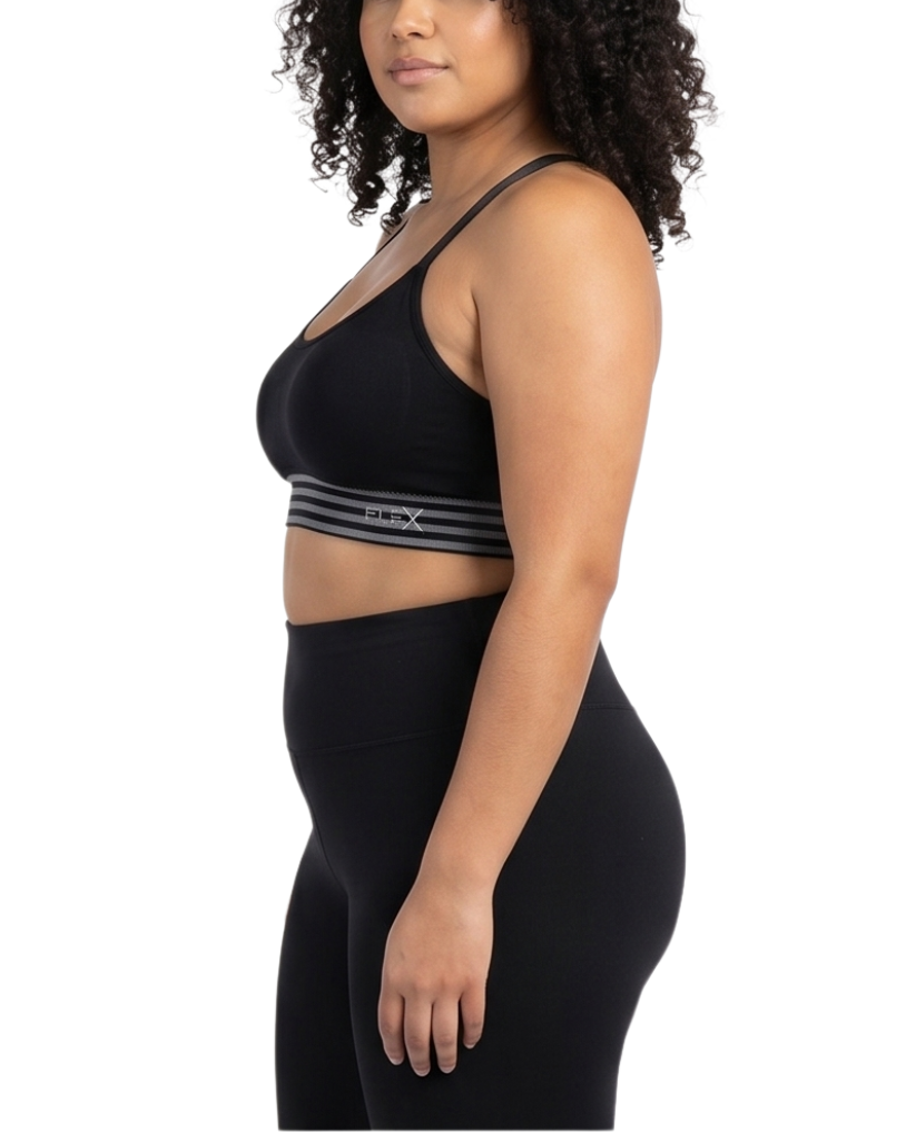 Woman wearing a black sports bra and leggings on a white background