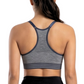 Woman wearing a gray sports bra and black leggings on a white background