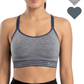 Woman wearing a gray sports bra with navy straps, featuring the brand 'Flex'.