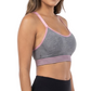 Woman wearing a gray sports bra and black leggings on a white background
