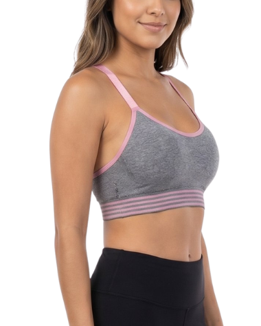 Woman wearing a gray sports bra and black leggings on a white background