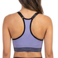 Woman wearing a purple sports bra and black leggings on a white background