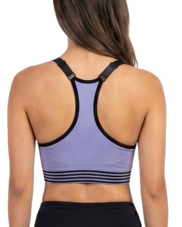 Woman wearing a purple sports bra and black leggings on a white background